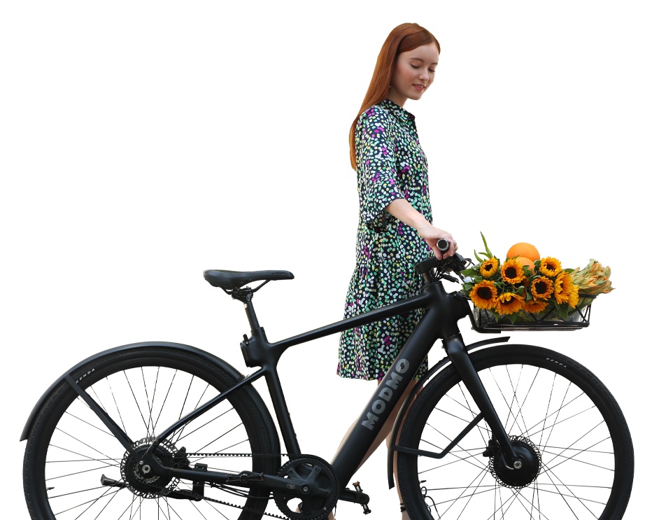 A rider with the Modmo Saigon ebike and a basket
