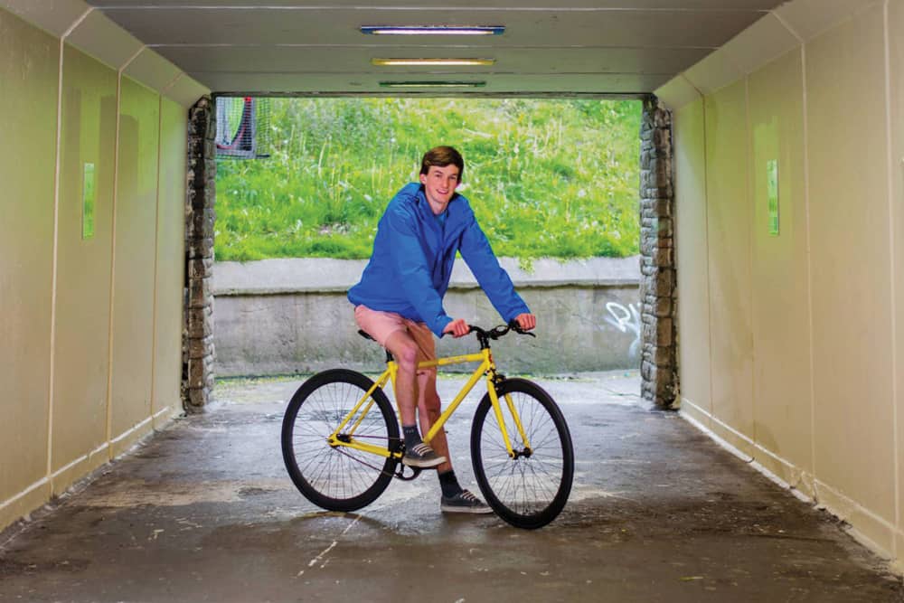 Jack at sixteen on a yellow Vital Fixies bike in a Dublin underpass — Business & Finance, Ones to Watch